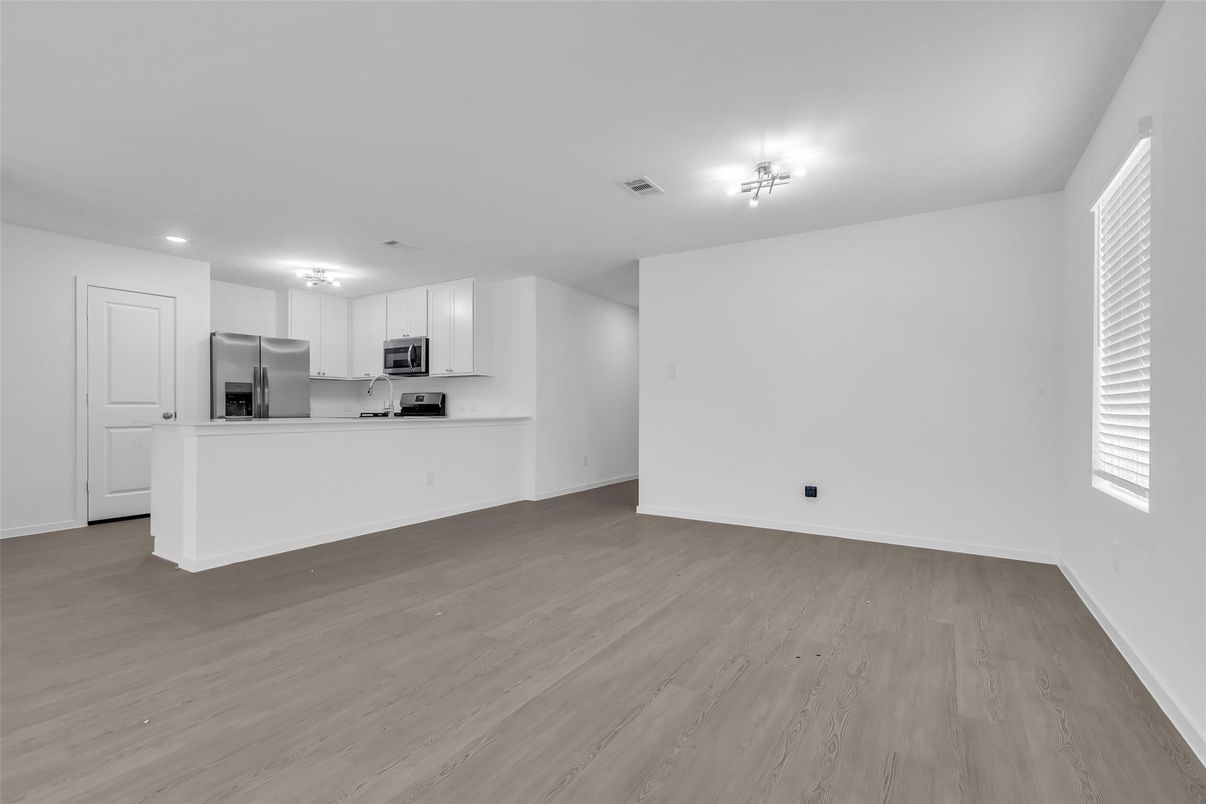 Empty room, Interior, Kitchen, Recessed Lighting, Stainless Steel Appliances, Wood Texture Flooring