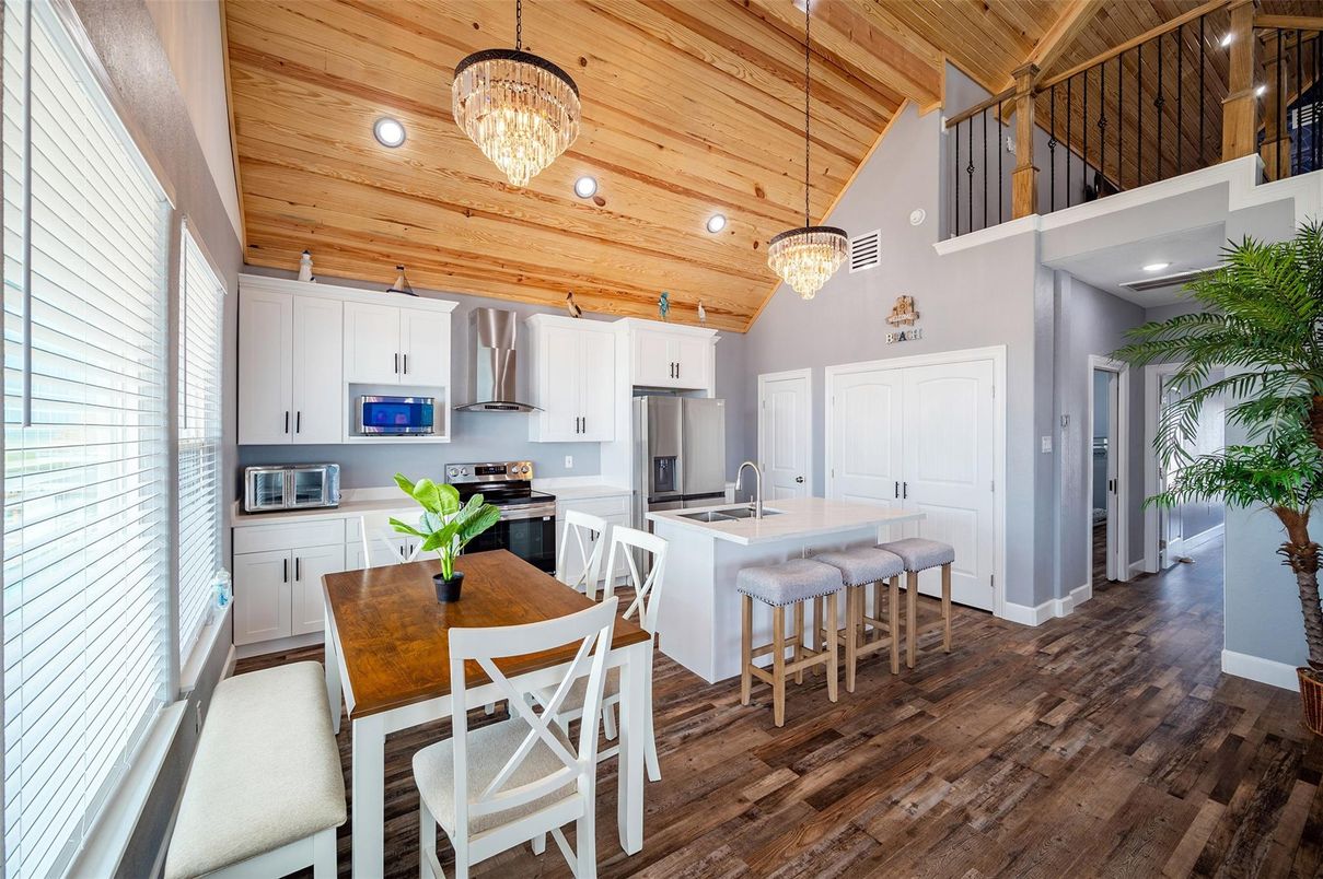 Chandelier, Dining room, Interior, Kitchen, Pendant Lights, Recessed Lighting, Stainless Steel Appliances, Wooden Ceilings, Wood Texture Flooring