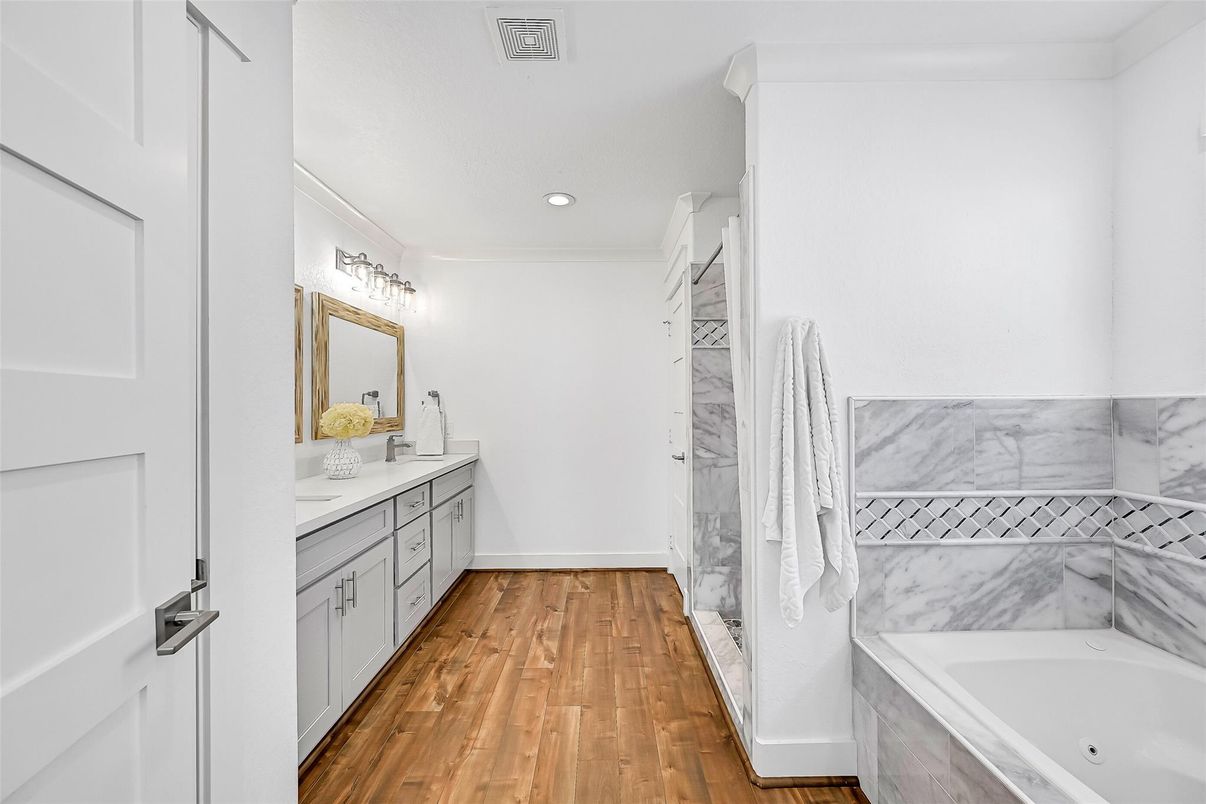 Bathroom, Dual Sink Vanities, Interior, Marble Walls, Recessed Lighting, Wood Texture Flooring
