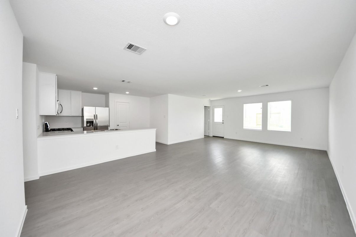 Empty room, Interior, Kitchen, Recessed Lighting, Stainless Steel Appliances, Wood Texture Flooring