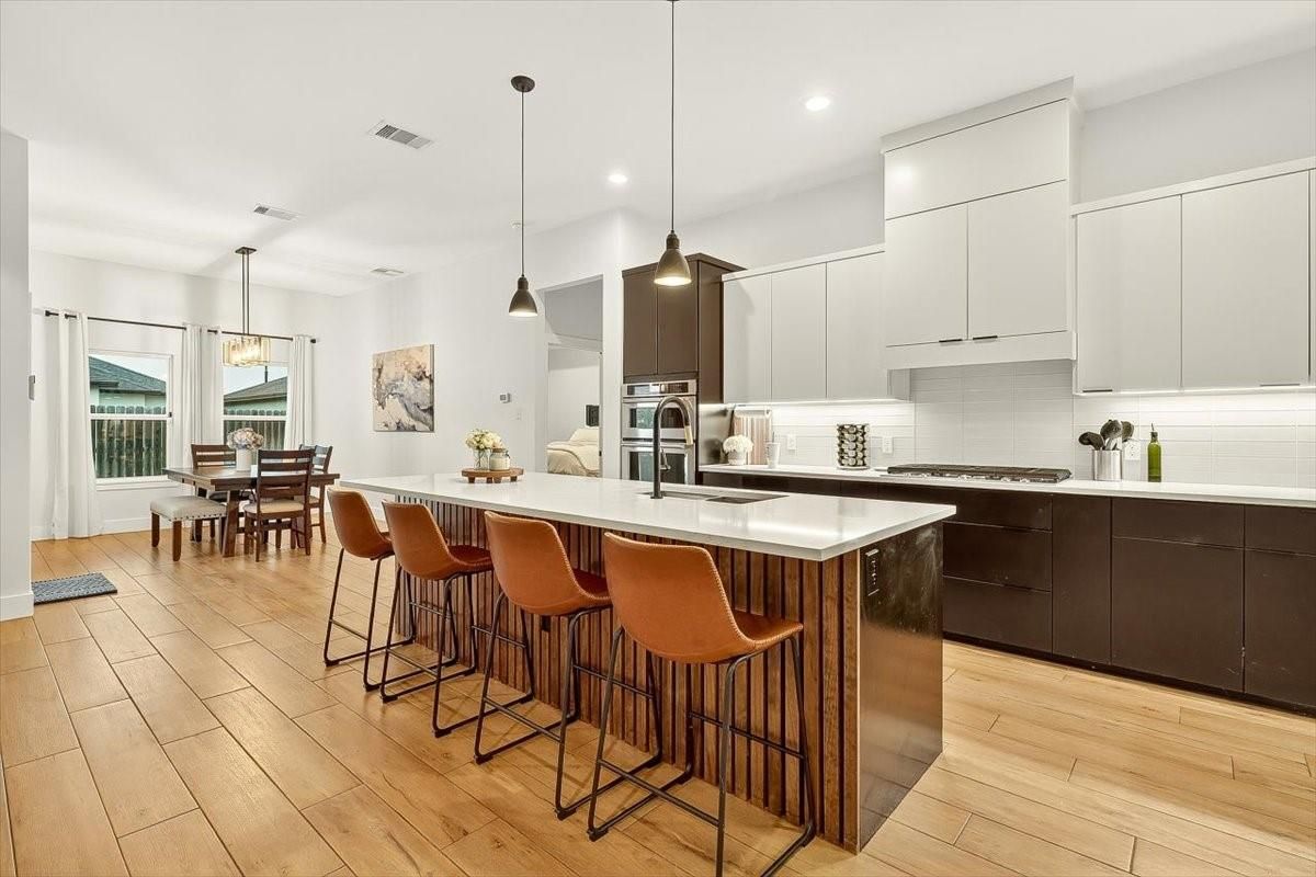 Dining room, Interior, Kitchen, Pendant Lights, Recessed Lighting, Stainless Steel Appliances, Wood Texture Flooring