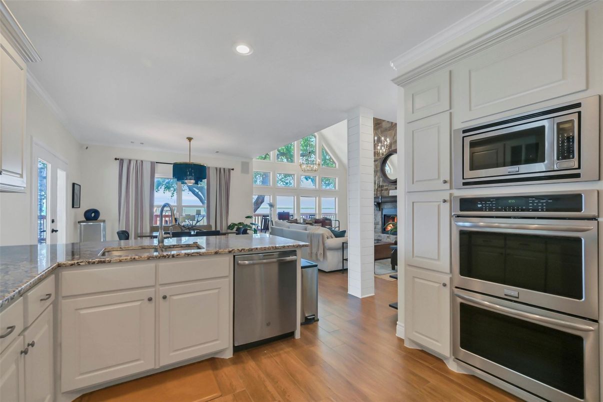 Fireplace, Interior, Kitchen, Recessed Lighting, Stainless Steel Appliances, Wood Texture Flooring