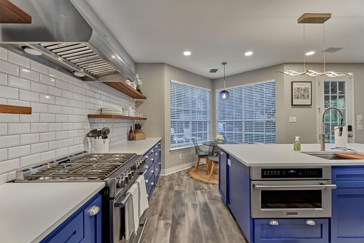 Dining room, Interior, Kitchen, Pendant Lights, Recessed Lighting, Stainless Steel Appliances, Wood Texture Flooring