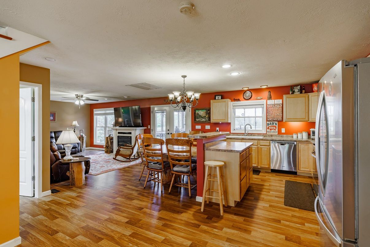 Chandelier, Dining room, Fireplace, Interior, Kitchen, Living room, Recessed Lighting, Stainless Steel Appliances, Wood Texture Flooring