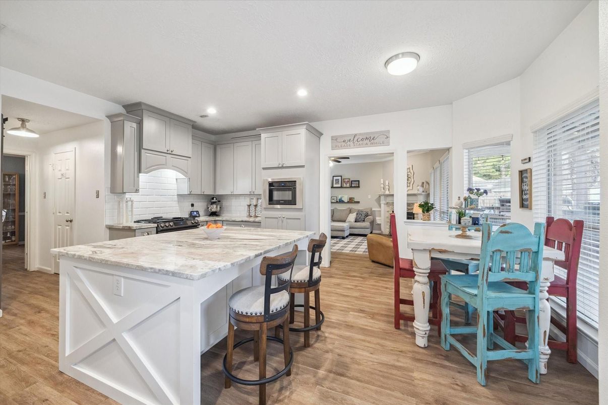 Dining room, Interior, Kitchen, Living room, Recessed Lighting, Stainless Steel Appliances, Wood Texture Flooring