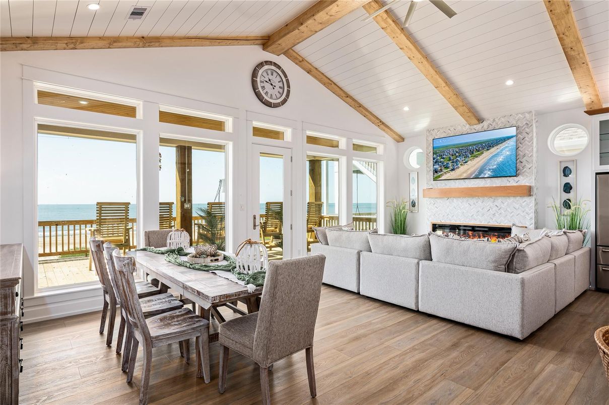 Dining room, Fireplace, Interior, Living room, Recessed Lighting, Water, Wooden Beams, Wood Texture Flooring