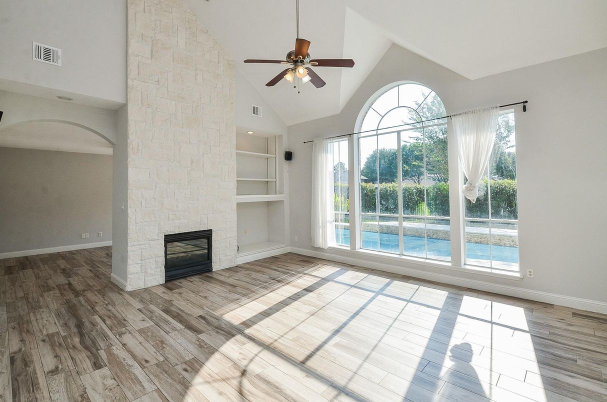 Empty room, Fireplace, Interior, Recessed Lighting, Stone Walls, Wood Texture Flooring