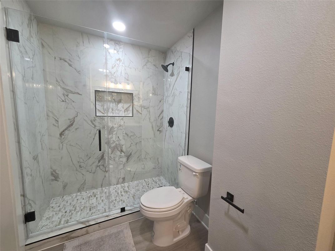 Bathroom, Glass Shower, Interior, Marble Walls, Recessed Lighting, Wood Texture Flooring
