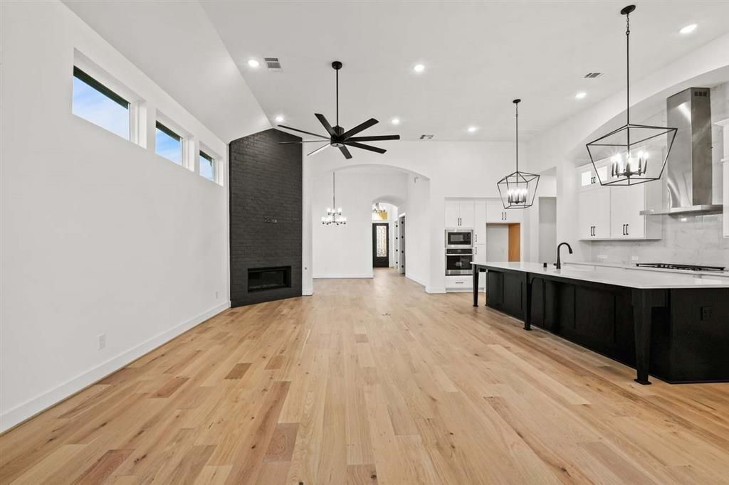 Chandelier, Fireplace, Interior, Kitchen, Pendant Lights, Recessed Lighting, Stainless Steel Appliances, Wood Texture Flooring