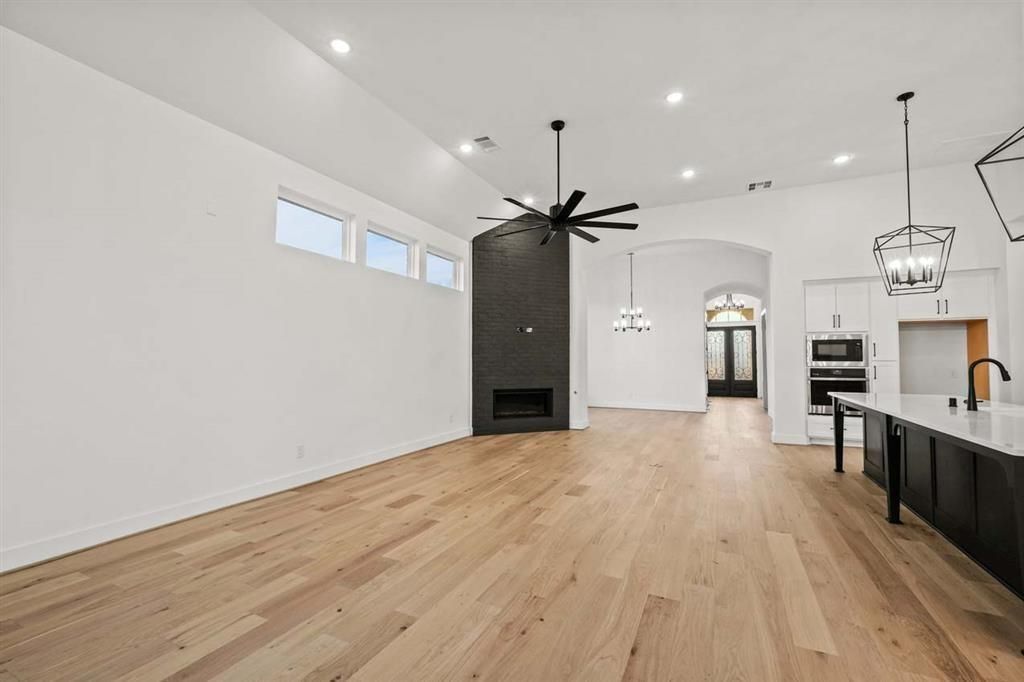 Chandelier, Empty room, Fireplace, Interior, Kitchen, Pendant Lights, Recessed Lighting, Wood Texture Flooring