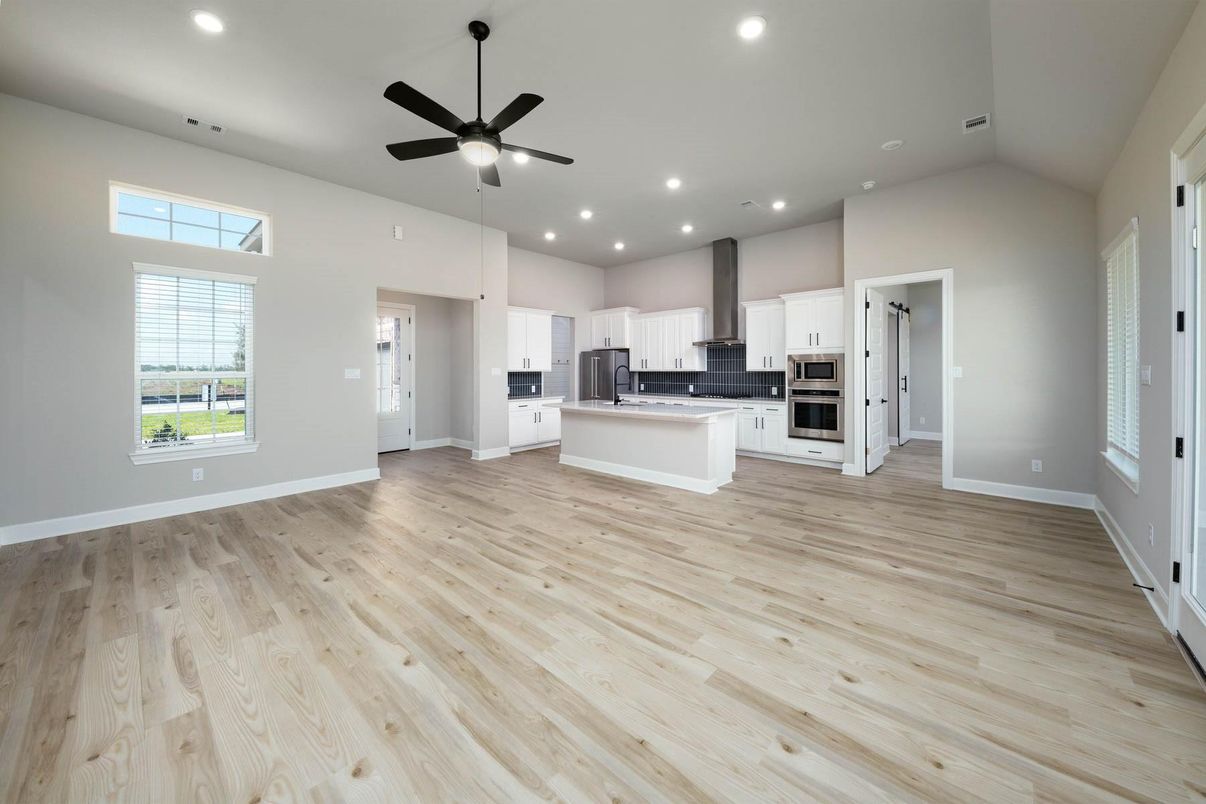 Empty room, Interior, Kitchen, Recessed Lighting, Stainless Steel Appliances, Wood Texture Flooring