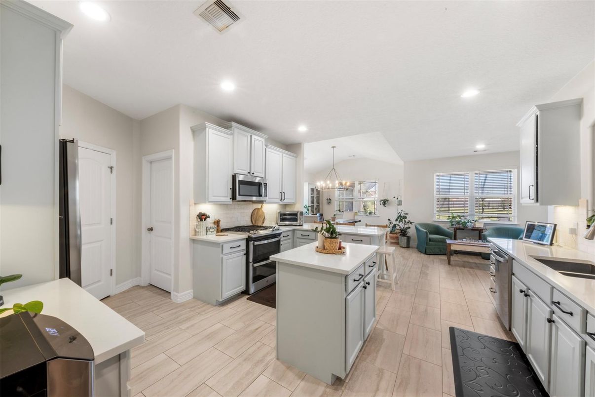Chandelier, Interior, Kitchen, Living room, Recessed Lighting, Stainless Steel Appliances, Wood Texture Flooring