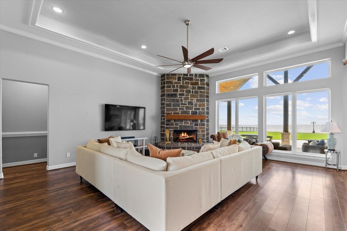Fireplace, Interior, Living room, Recessed Lighting, Stone Walls, Water, Wood Texture Flooring