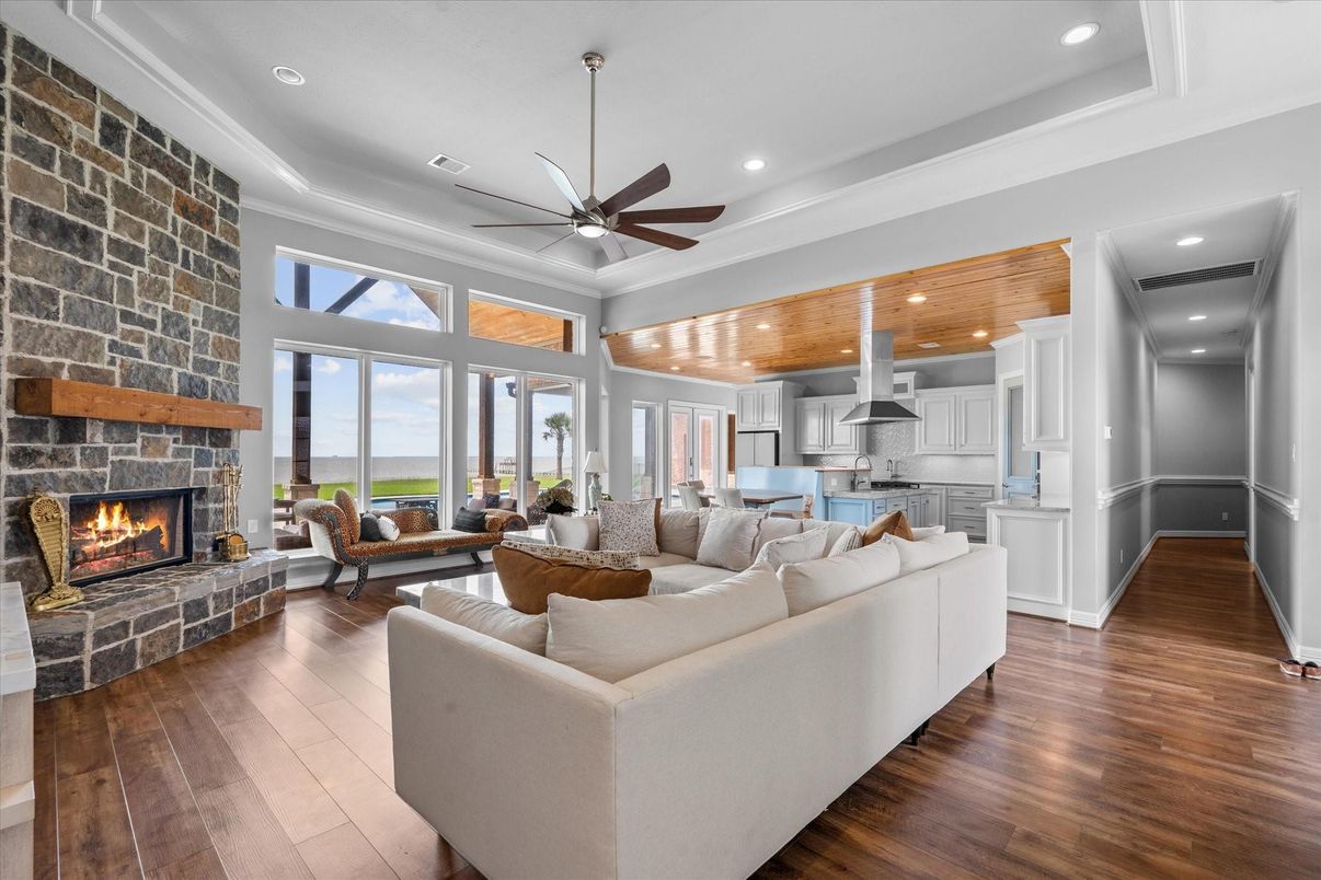 Fireplace, Interior, Kitchen, Living room, Pendant Lights, Recessed Lighting, Stainless Steel Appliances, Stone Walls, Wood Texture Flooring