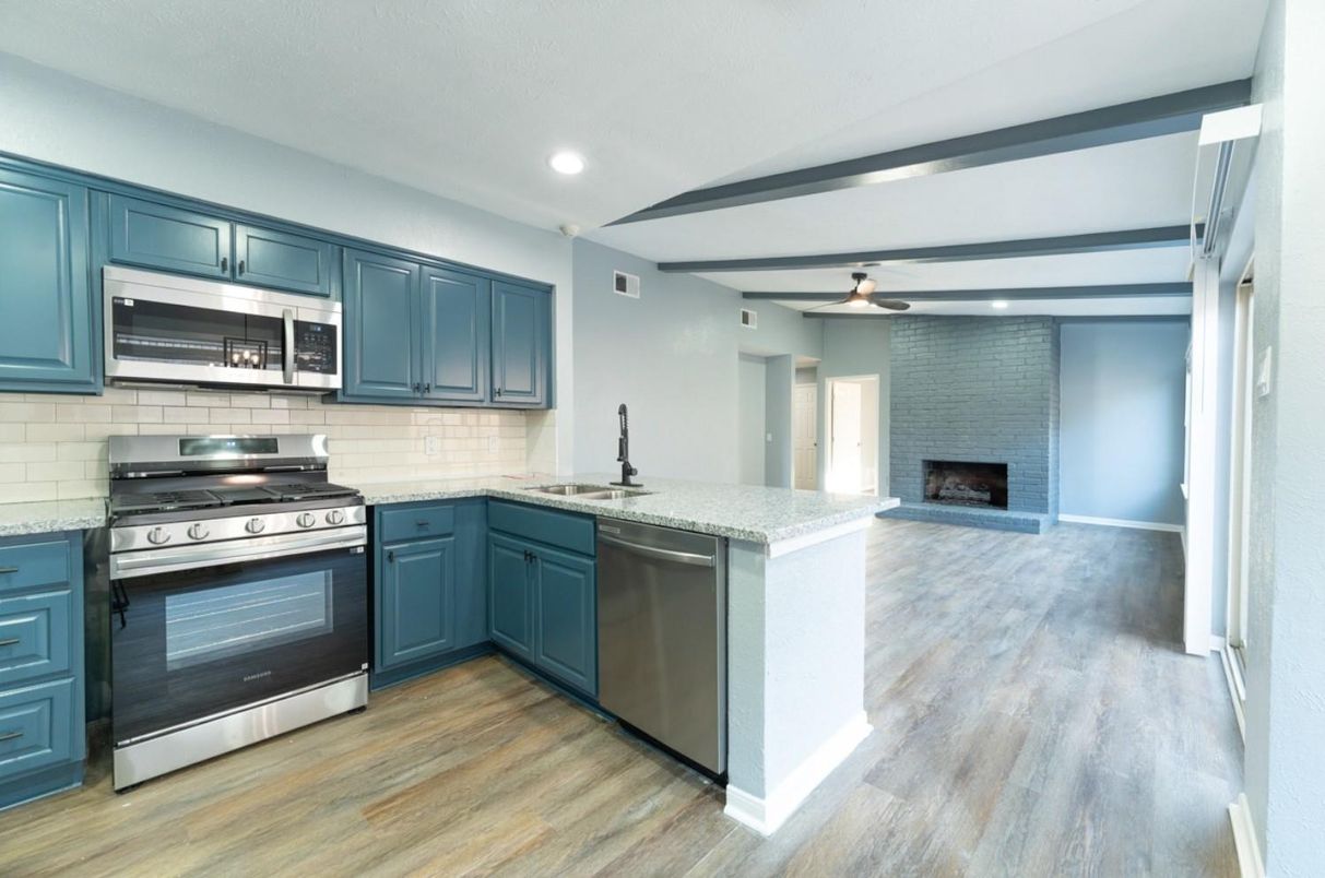 Fireplace, Interior, Kitchen, Recessed Lighting, Stainless Steel Appliances, Stone Walls, Wood Texture Flooring