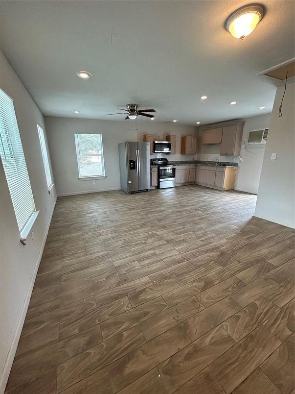 Empty room, Interior, Kitchen, Recessed Lighting, Stainless Steel Appliances, Wood Texture Flooring