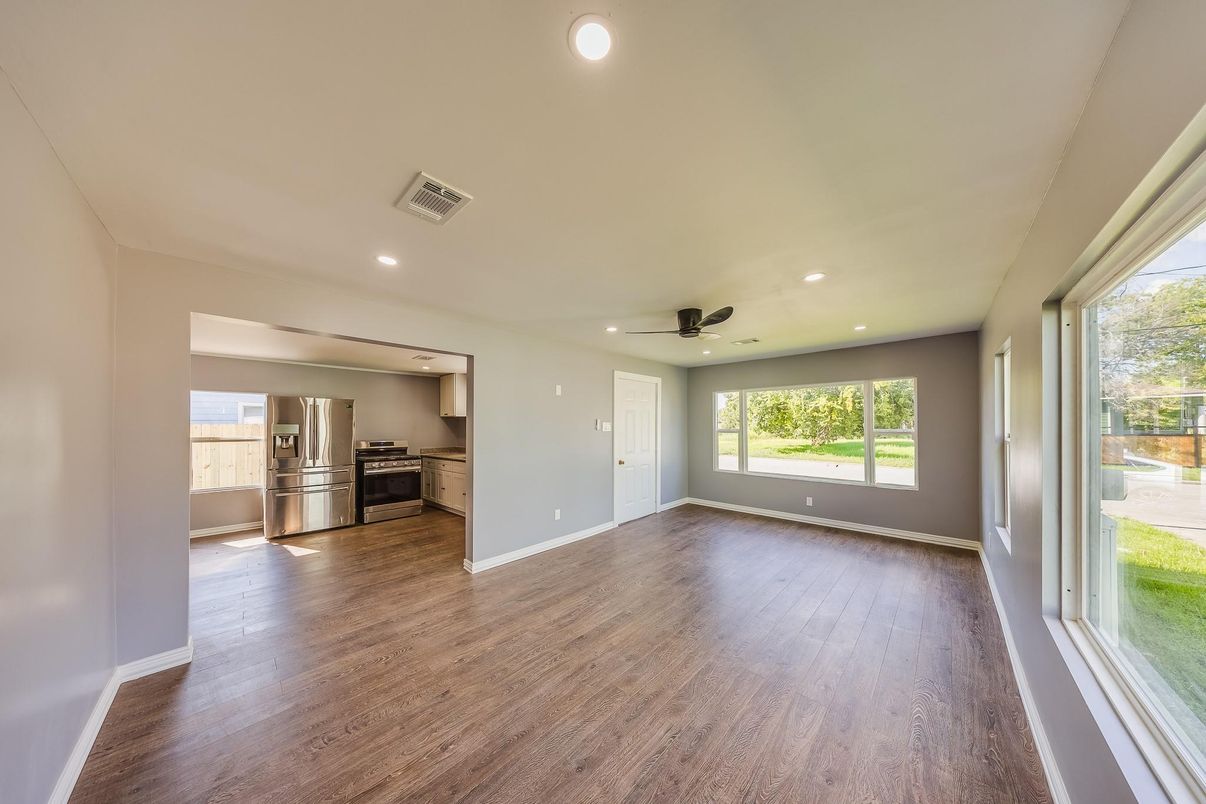 Empty room, Interior, Kitchen, Recessed Lighting, Stainless Steel Appliances, Wood Texture Flooring