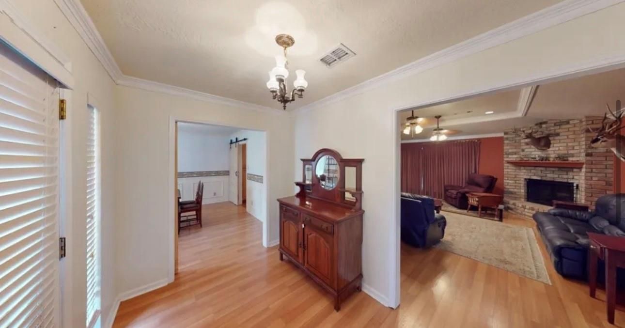 Chandelier, Fireplace, Interior, Living room, Recessed Lighting, Stone Walls, Wood Texture Flooring
