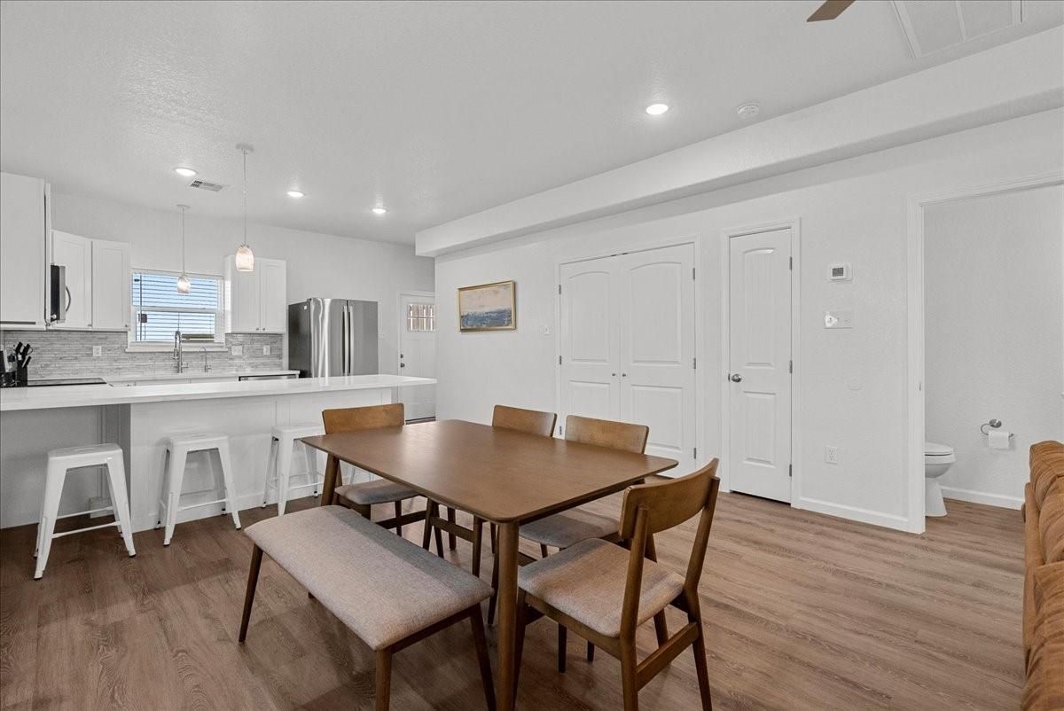 Dining room, Interior, Kitchen, Pendant Lights, Recessed Lighting, Stainless Steel Appliances, Wood Texture Flooring