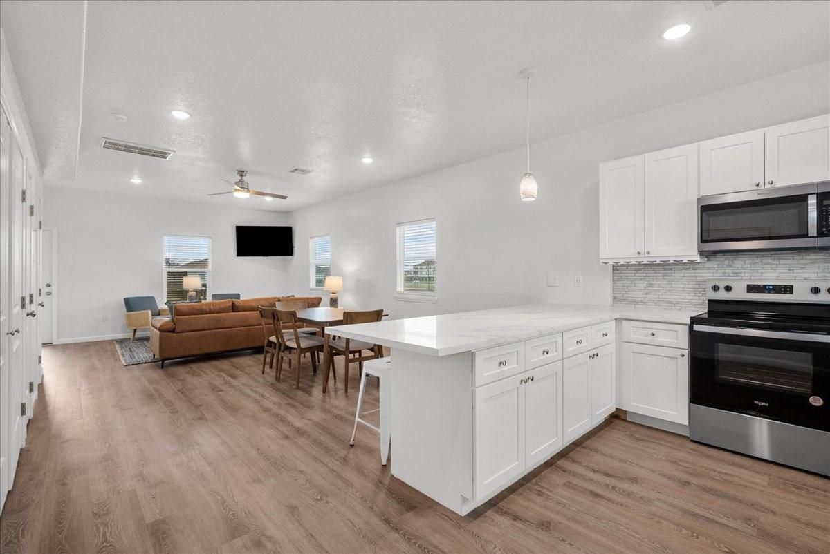 Dining room, Interior, Kitchen, Living room, Pendant Lights, Recessed Lighting, Stainless Steel Appliances, Wood Texture Flooring