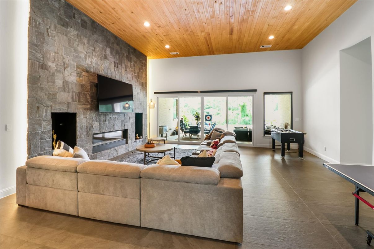 Fireplace, Game Room, Interior, Living room, Recessed Lighting, Stone Walls, Wooden Ceilings