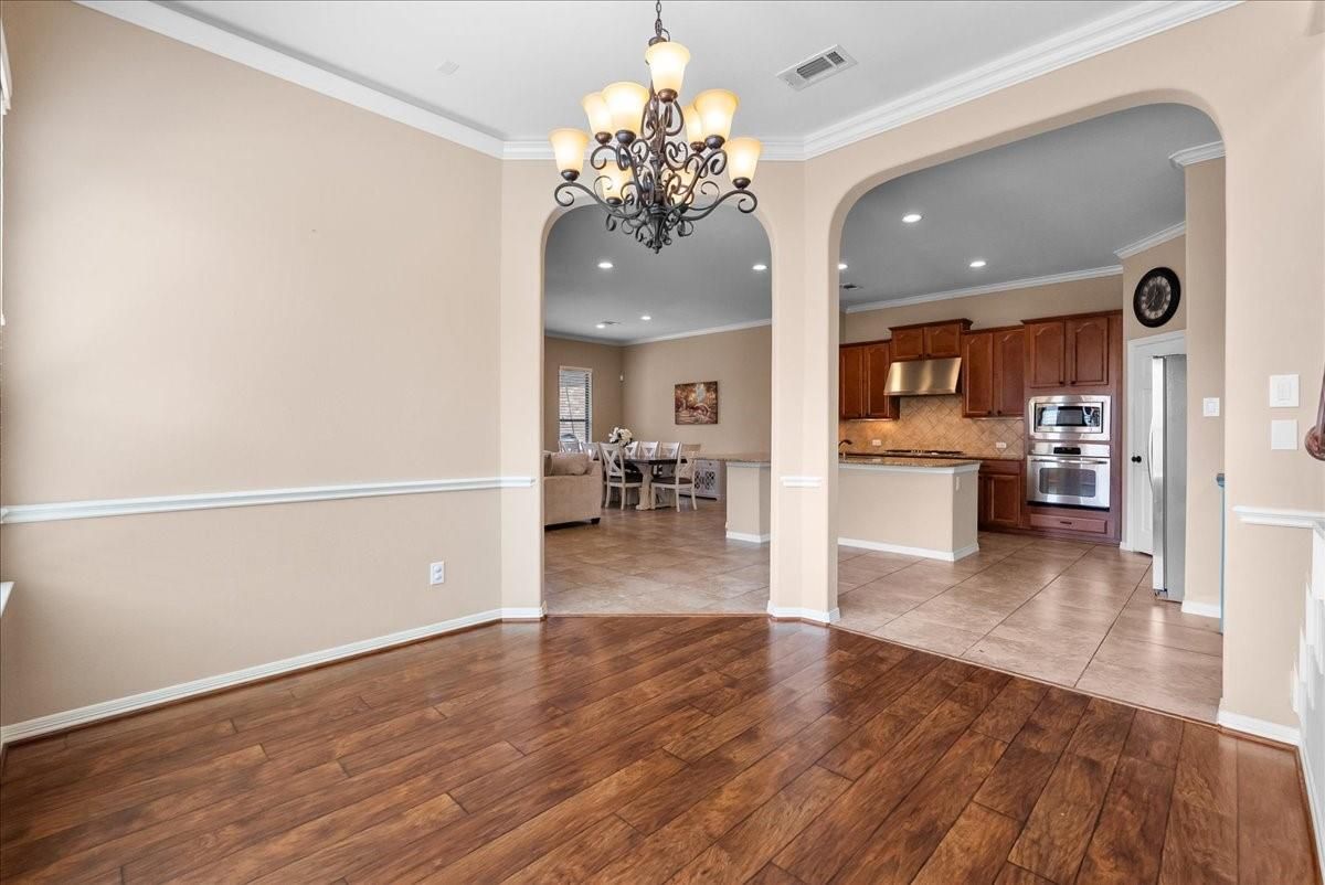 Chandelier, Dining room, Interior, Kitchen, Recessed Lighting, Stainless Steel Appliances, Wood Texture Flooring