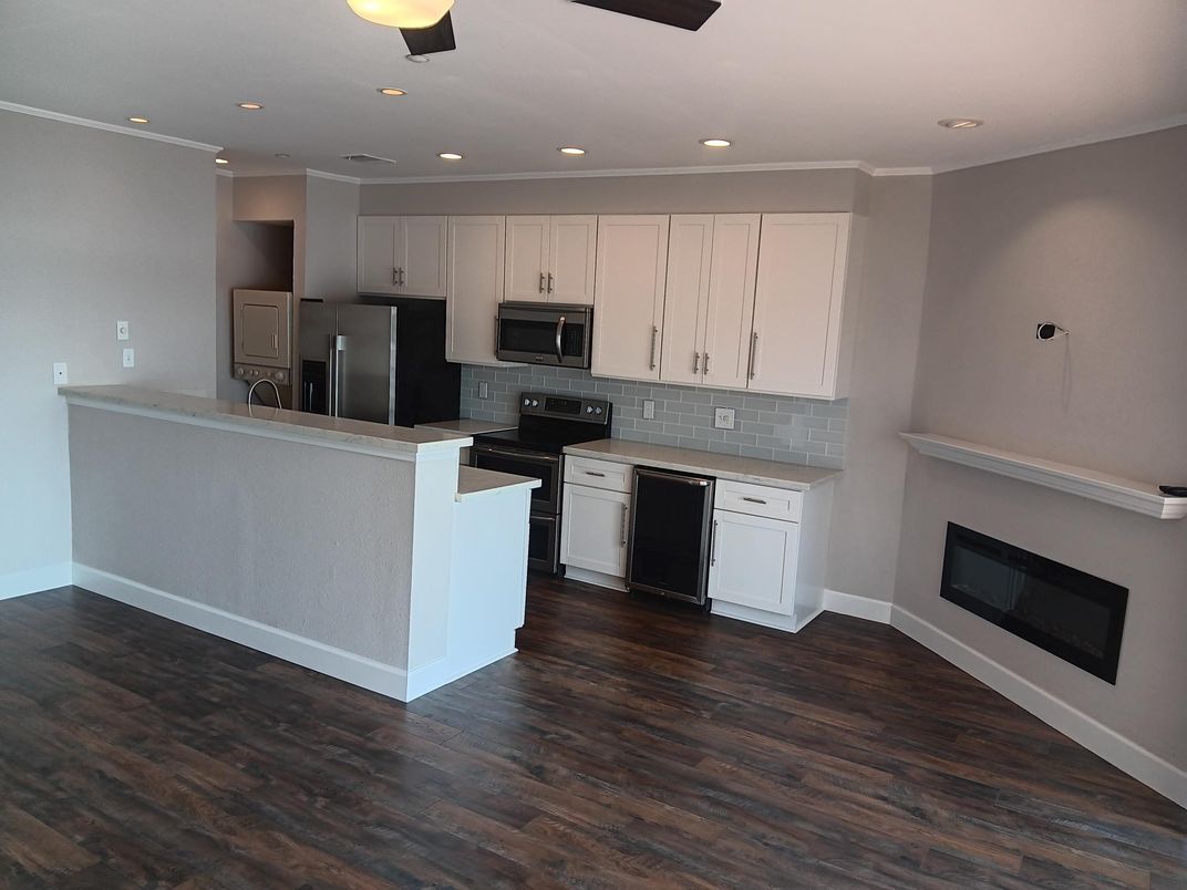 Fireplace, Interior, Kitchen, Recessed Lighting, Stainless Steel Appliances, Wood Texture Flooring