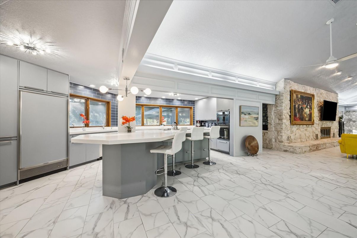 Fireplace, Interior, Kitchen, Marble, Pendant Lights, Stainless Steel Appliances, Stone Walls