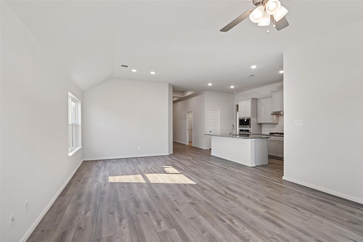 Empty room, Interior, Kitchen, Recessed Lighting, Stainless Steel Appliances, Wood Texture Flooring