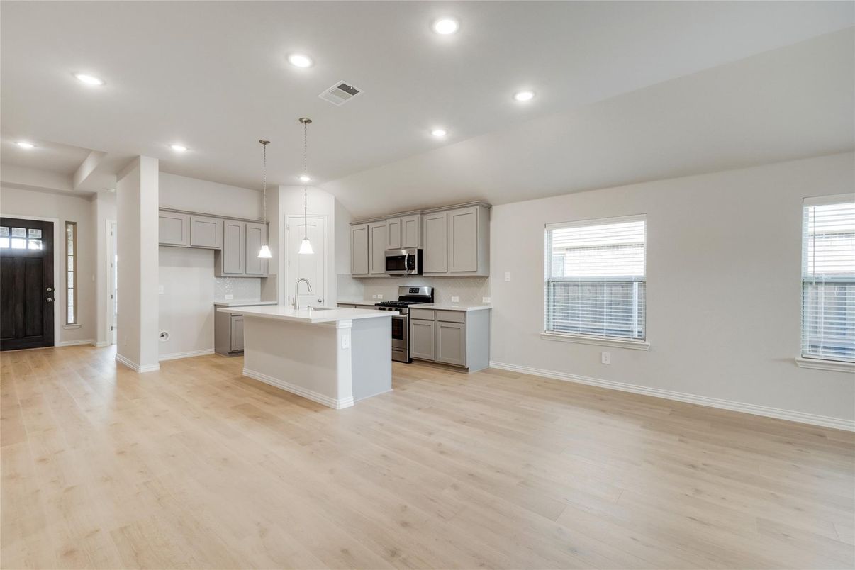 Empty room, Interior, Kitchen, Pendant Lights, Recessed Lighting, Stainless Steel Appliances, Wood Texture Flooring