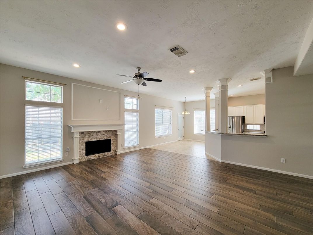 Empty room, Fireplace, Interior, Kitchen, Pendant Lights, Recessed Lighting, Wood Texture Flooring