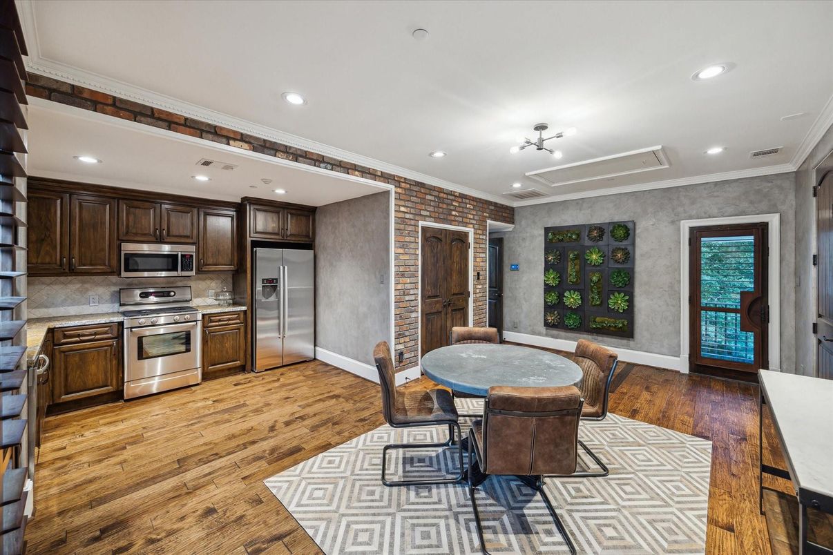 Dining room, Interior, Kitchen, Recessed Lighting, Stainless Steel Appliances, Stone Walls, Wood Texture Flooring