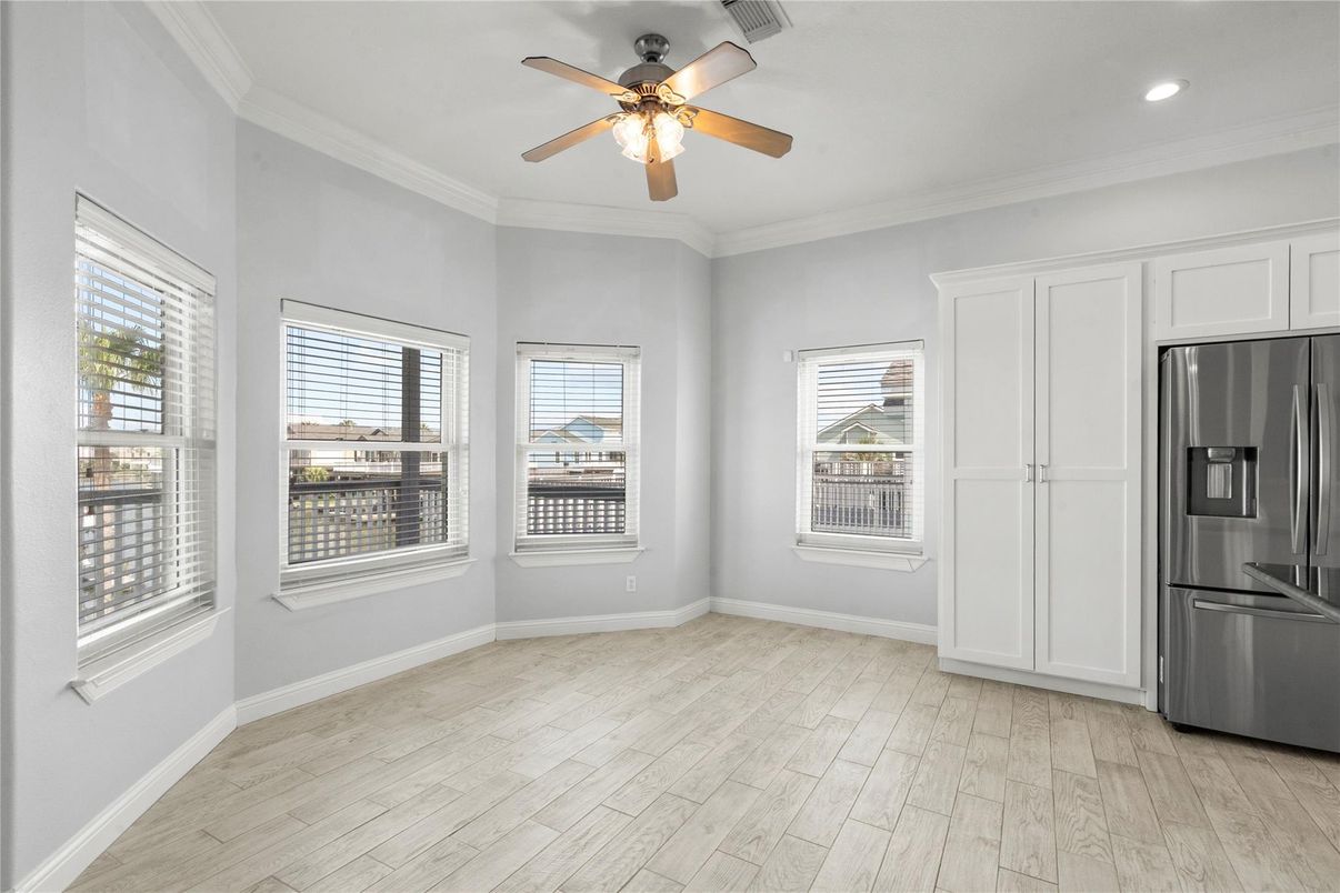 Empty room, Interior, Kitchen, Recessed Lighting, Stainless Steel Appliances, Wood Texture Flooring