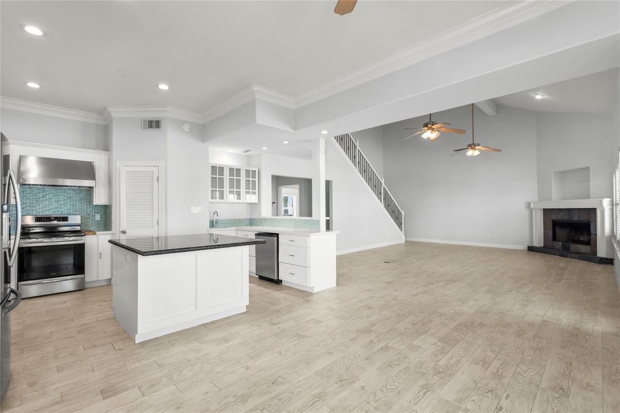Fireplace, Interior, Kitchen, Pendant Lights, Recessed Lighting, Stainless Steel Appliances, Wood Texture Flooring
