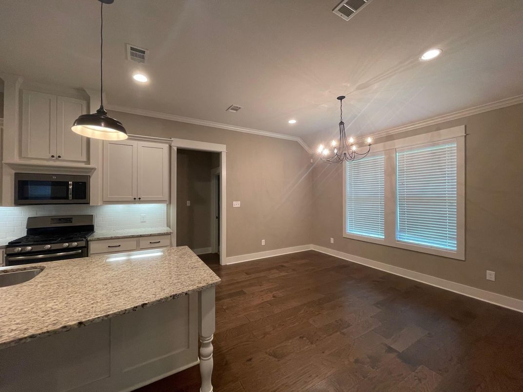 Chandelier, Empty room, Interior, Kitchen, Pendant Lights, Recessed Lighting, Stainless Steel Appliances, Wood Texture Flooring