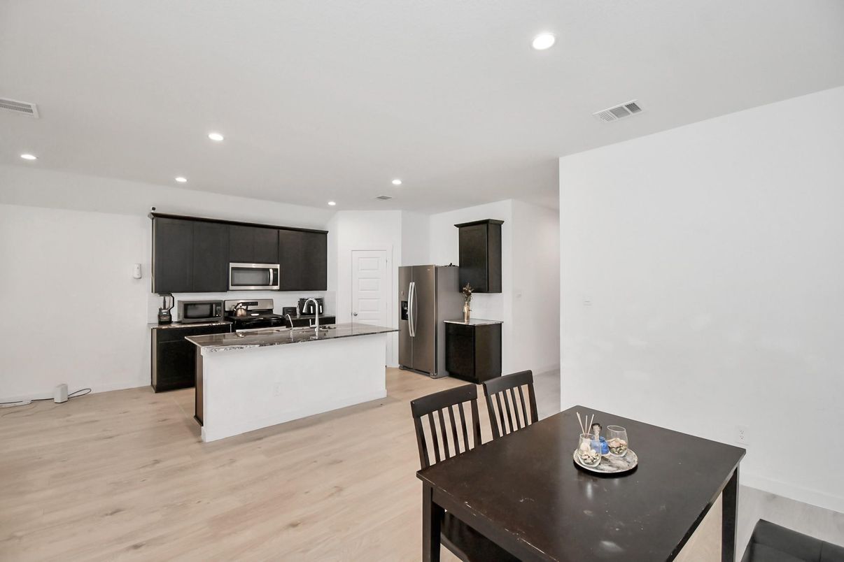 Dining room, Interior, Kitchen, Recessed Lighting, Stainless Steel Appliances, Wood Texture Flooring