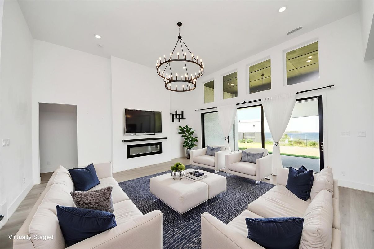 Chandelier, Fireplace, Interior, Living room, Pendant Lights, Recessed Lighting, Water, Wood Texture Flooring