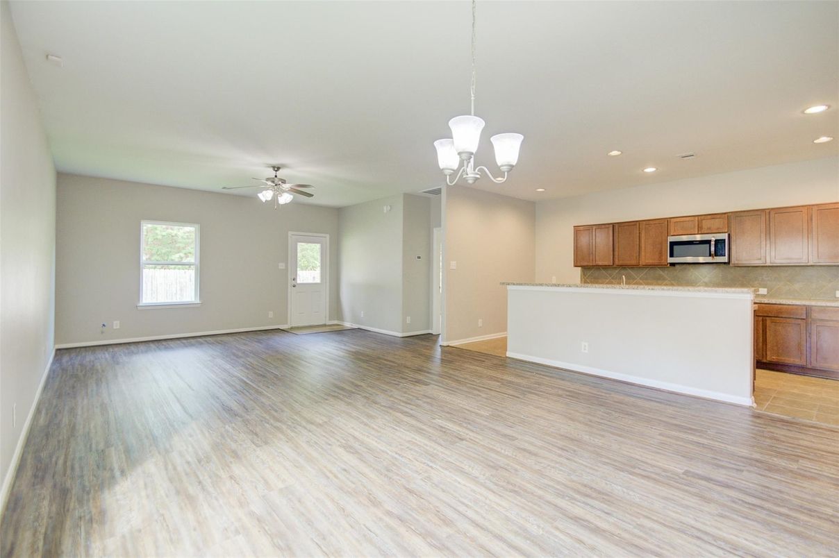 Chandelier, Empty room, Interior, Kitchen, Pendant Lights, Recessed Lighting, Stainless Steel Appliances, Wood Texture Flooring