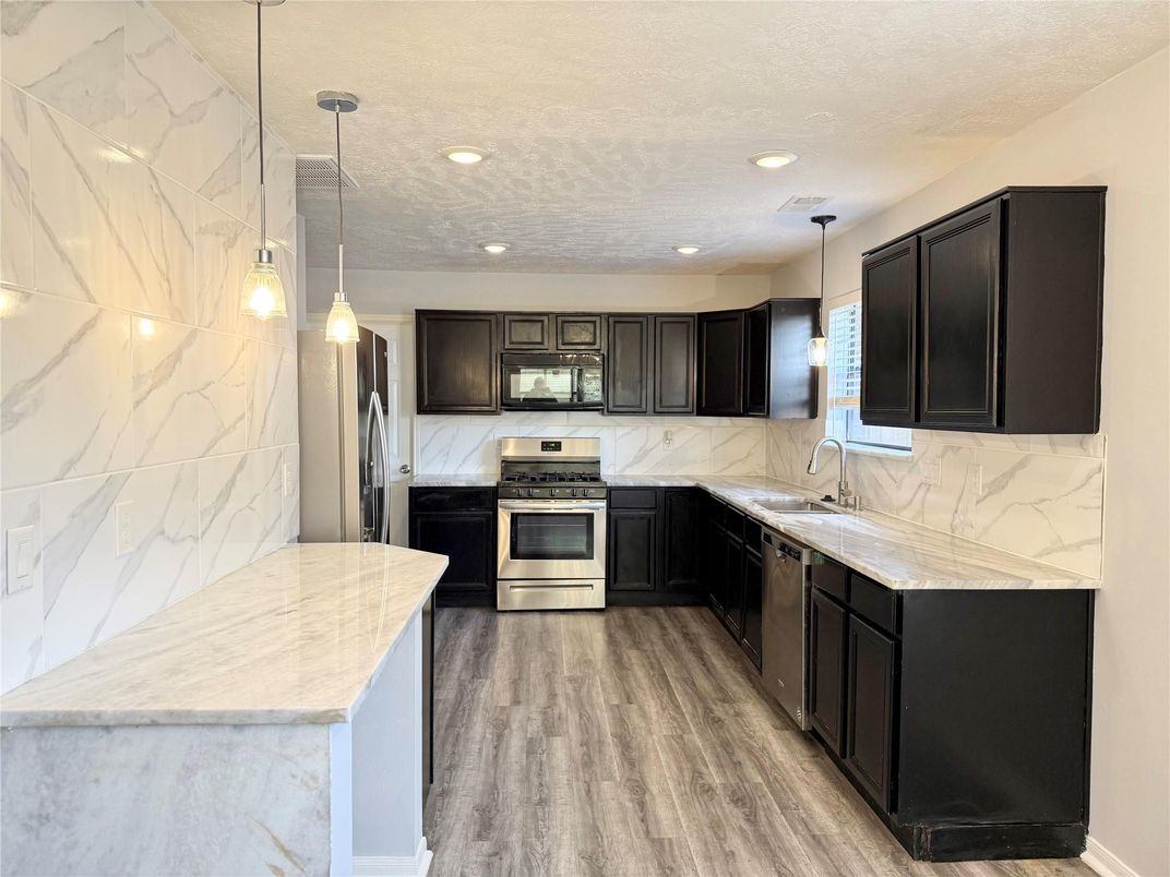 Interior, Kitchen, Marble Walls, Pendant Lights, Recessed Lighting, Stainless Steel Appliances, Wood Texture Flooring