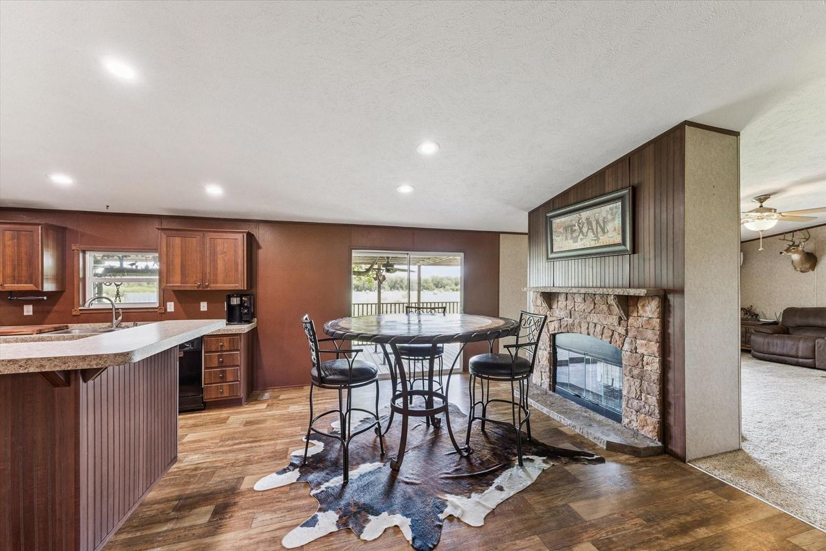 Dining room, Fireplace, Interior, Kitchen, Recessed Lighting, Wood Texture Flooring