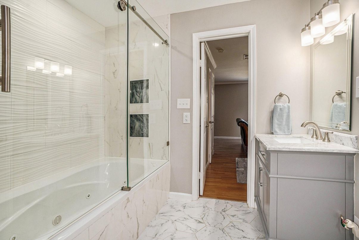 Bathroom, Dual Sink Vanities, Glass Shower, Interior, Marble, Wood Texture Flooring