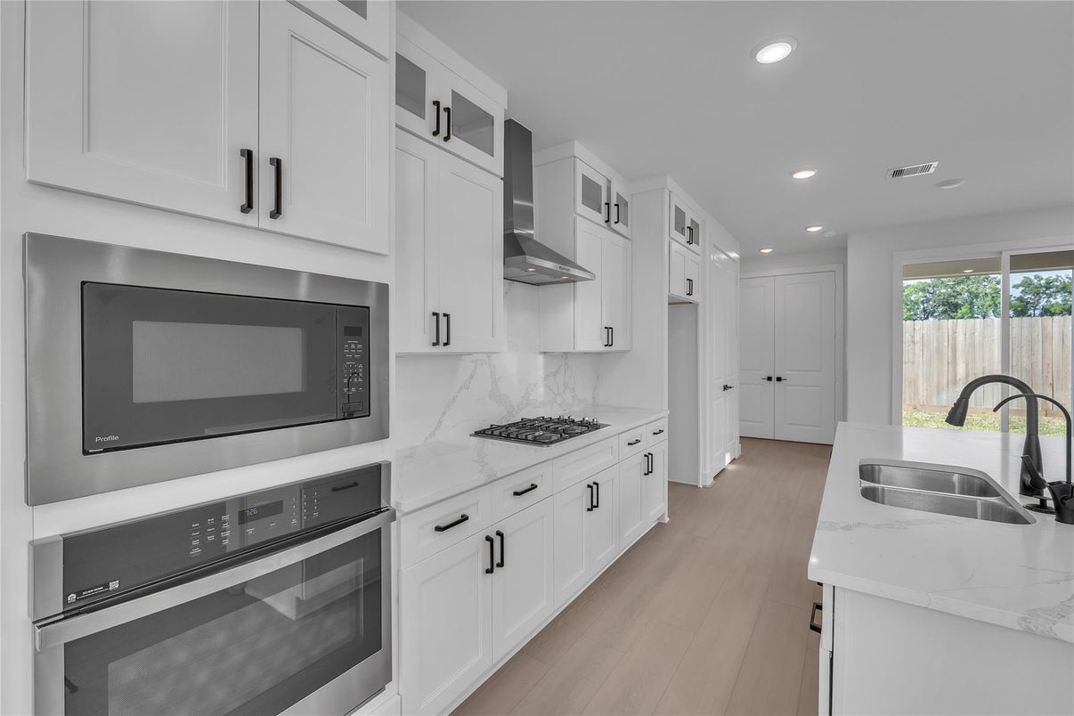 Interior, Kitchen, Marble Walls, Recessed Lighting, Stainless Steel Appliances, Wood Texture Flooring