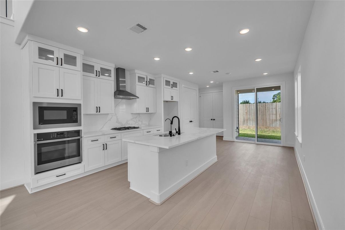Interior, Kitchen, Marble Walls, Recessed Lighting, Stainless Steel Appliances, Wood Texture Flooring