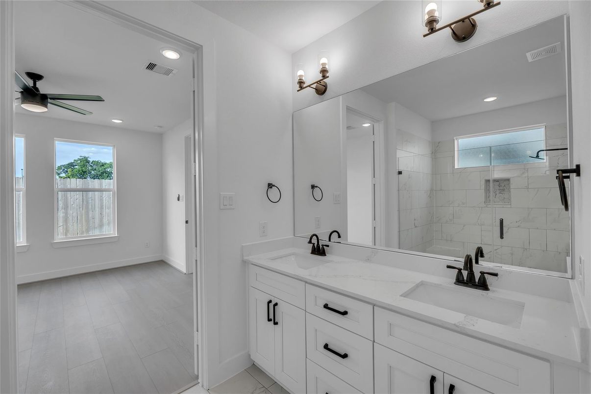 Bathroom, Dual Sink Vanities, Glass Shower, Interior, Marble Walls, Recessed Lighting, Wood Texture Flooring