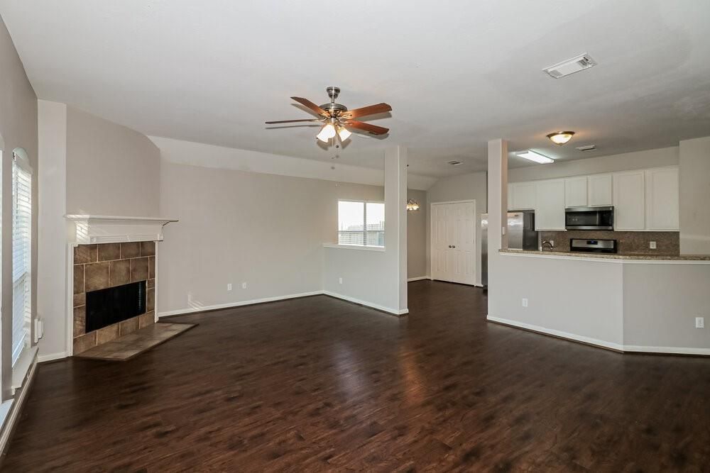 Empty room, Fireplace, Interior, Kitchen, Stainless Steel Appliances, Wood Texture Flooring