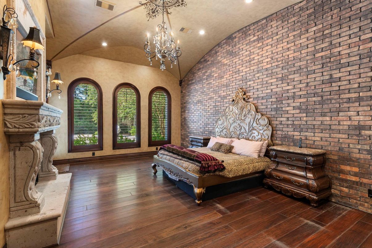Bedroom, Chandelier, Fireplace, Interior, Recessed Lighting, Stone Walls, Wood Texture Flooring