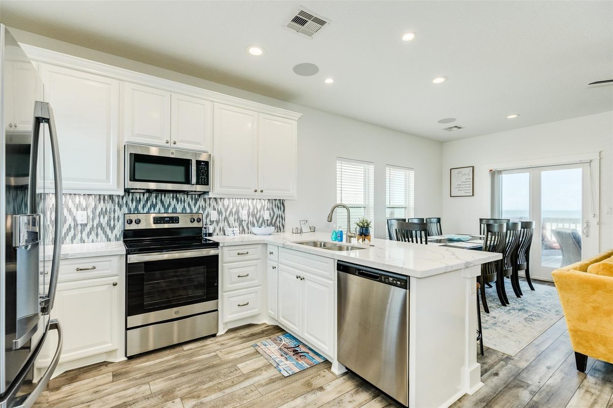 Dining room, Interior, Kitchen, Recessed Lighting, Stainless Steel Appliances, Wood Texture Flooring