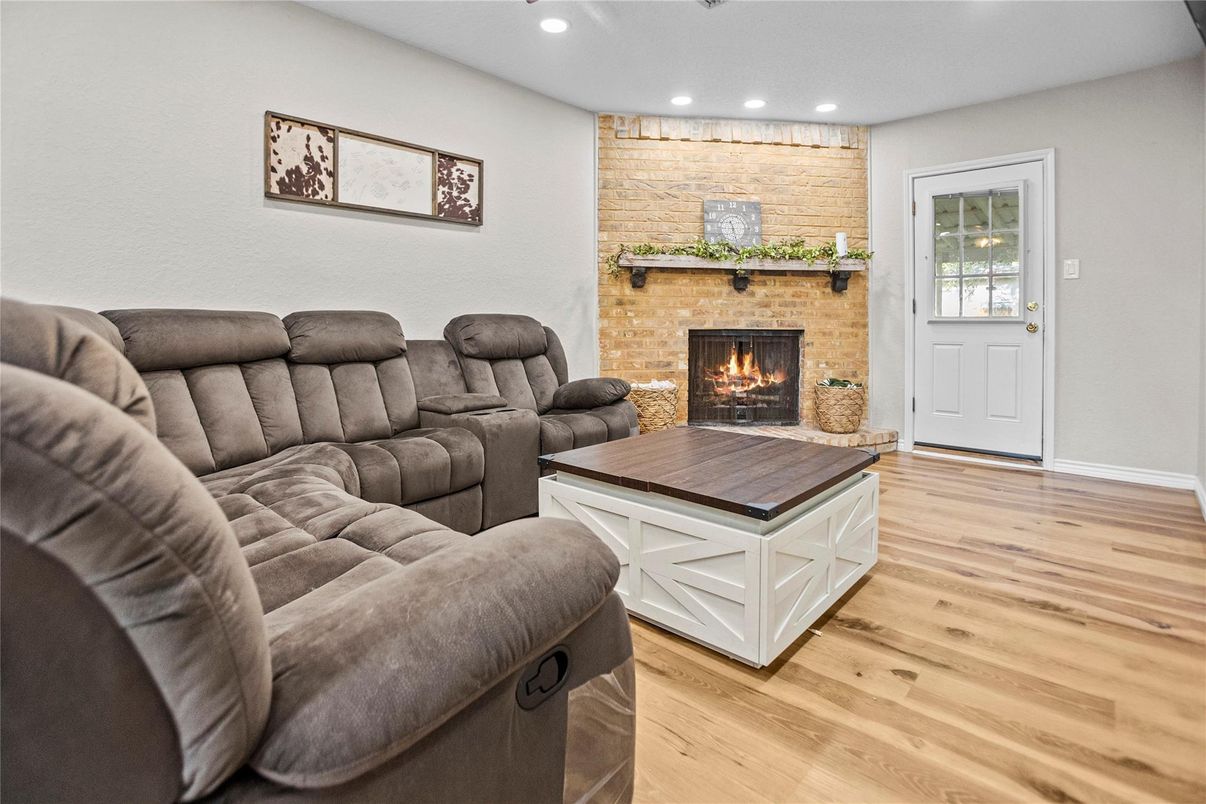 Fireplace, Interior, Living room, Recessed Lighting, Stone Walls, Wood Texture Flooring