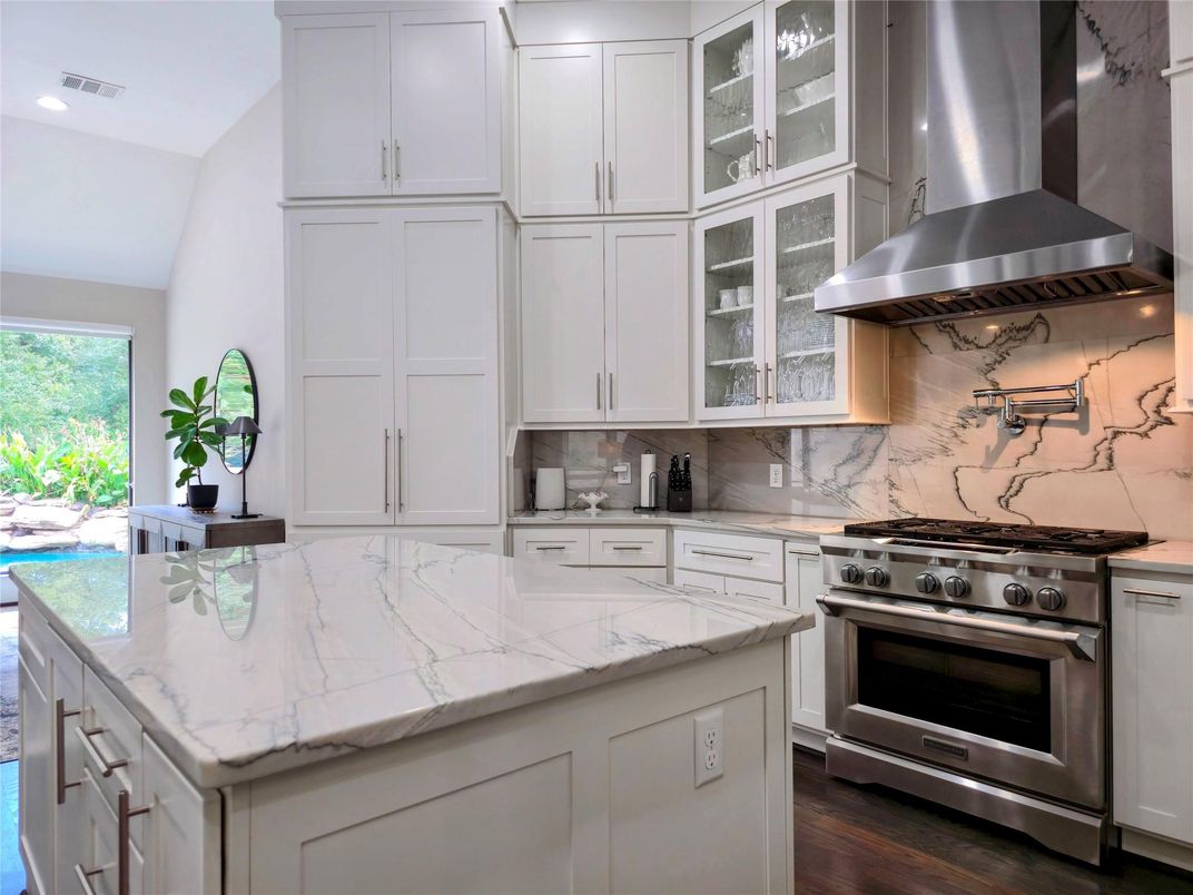 Interior, Kitchen, Marble Walls, Recessed Lighting, Stainless Steel Appliances, Wood Texture Flooring