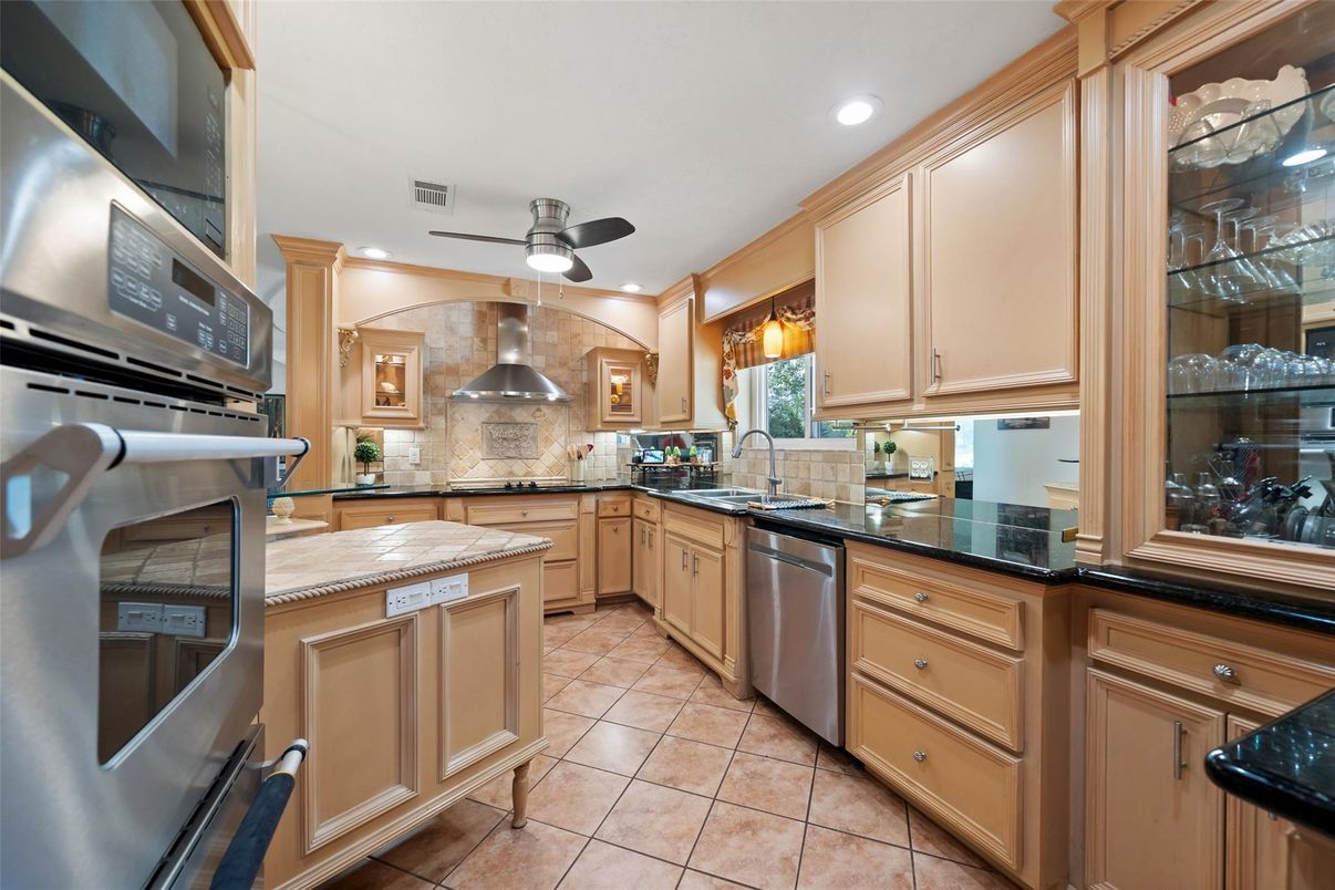 Interior, Kitchen, Recessed Lighting, Stainless Steel Appliances, Stone Walls, Tile Countertops